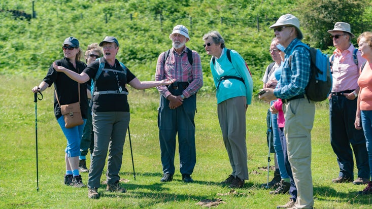 Visitors experiencing a guided walk around Tarn Hows, Cumbria